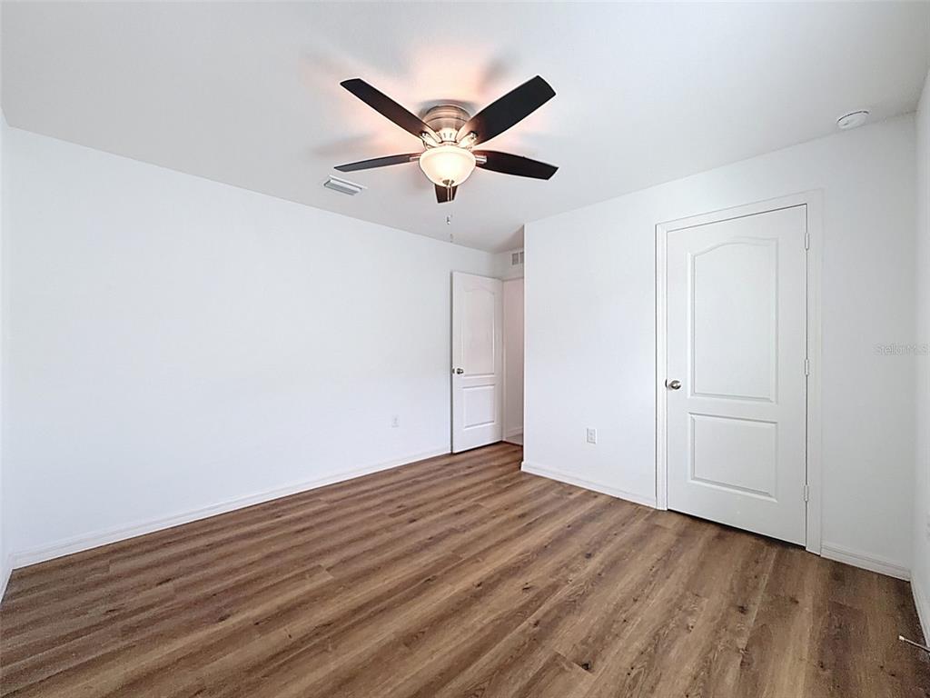 12943 Impatiens Street Spring Hill, FL 34609 - Photo 37 of 53 a view of empty room with wooden floor