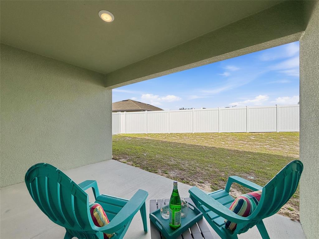 12943 Impatiens Street Spring Hill, FL 34609 - Photo 41 of 53 a view of an chairs and table in patio
