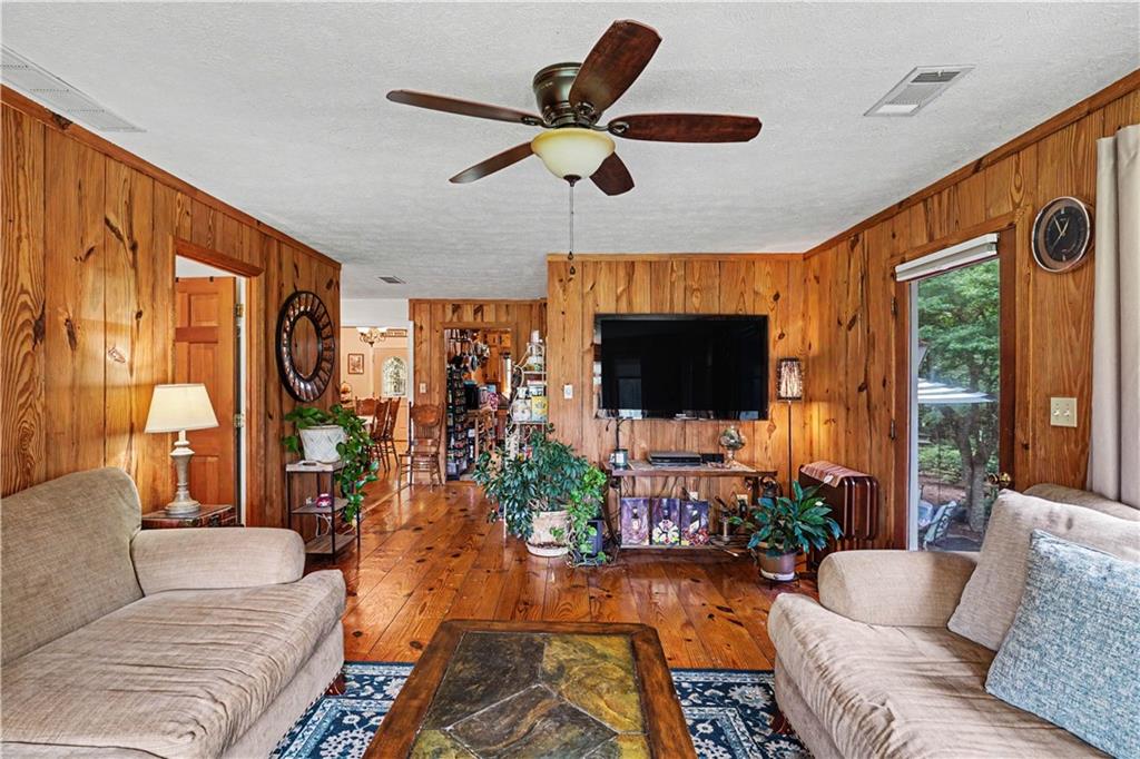 355 Inman Road Hampton, GA 30228 - Photo 12 of 47 a living room with furniture a flat screen tv and a large window