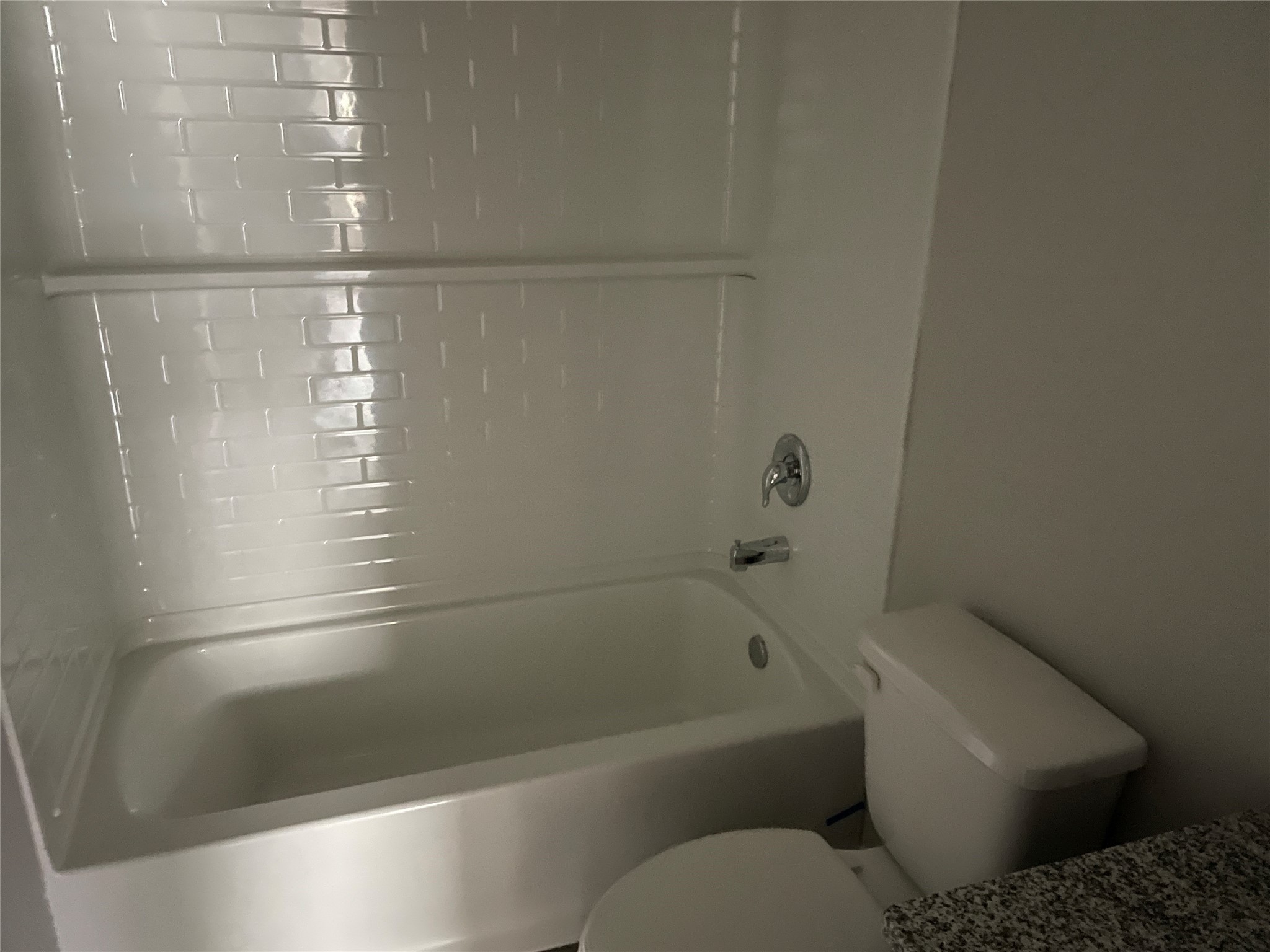 827 Redinger Ridge Drive Huffman, TX 77336 - Photo 14 of 16 a bathroom with a toilet and a bathtub