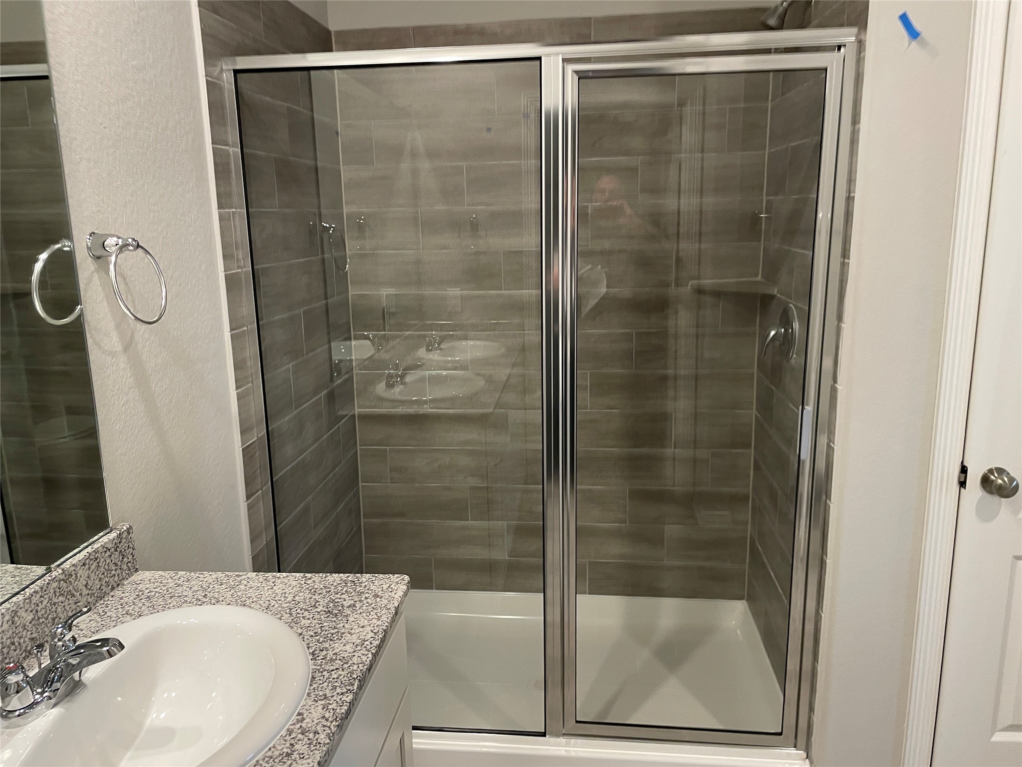 827 Redinger Ridge Drive Huffman, TX 77336 - Photo 8 of 16 a bathroom with a granite countertop sink mirror and shower