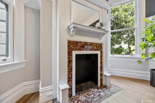a living room with a fireplace and a window