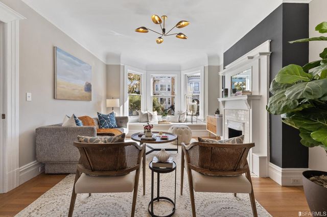 a dining room with furniture and a potted plant