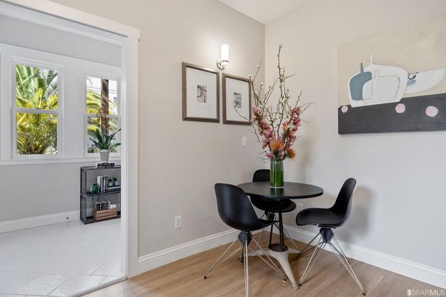 a view of a workspace with furniture and a potted plant