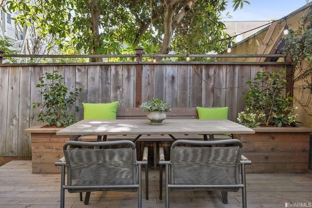 a view of outdoor dining space with a table and chairs