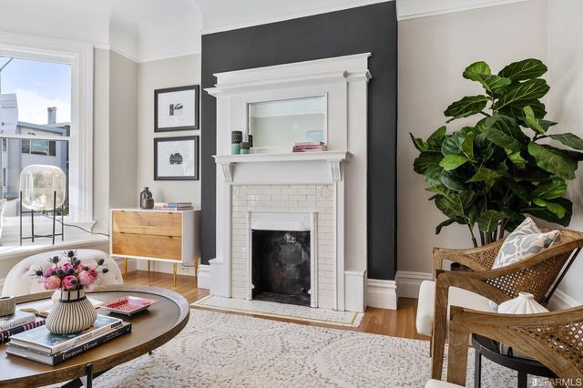 a living room with furniture and a fireplace