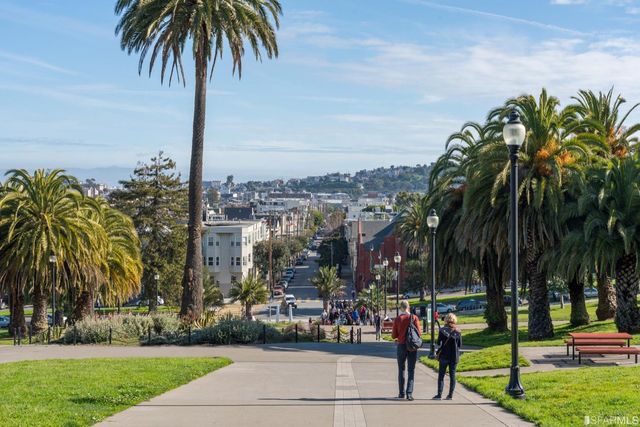 a view of multiple houses with a park