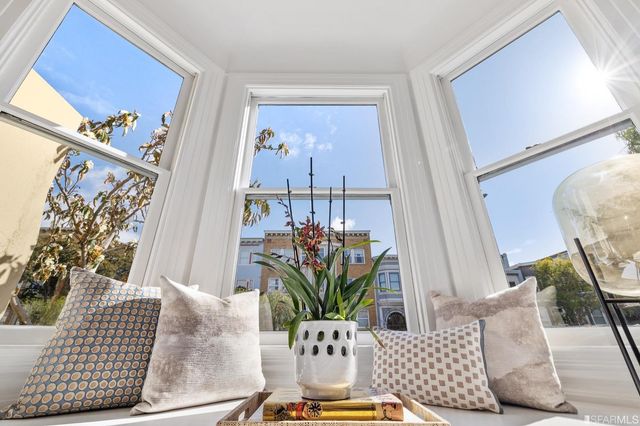 a living room with furniture and flowers
