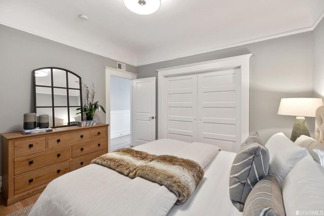 a bedroom with a bed and a dresser