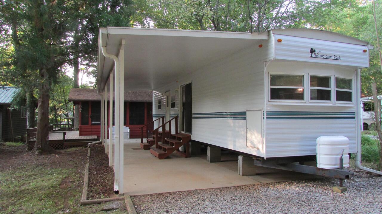 271 Hidden Valley Road, Unit 30 Cleveland, GA 30528 - Photo 1 of 1 a view of a house with a patio and a yard