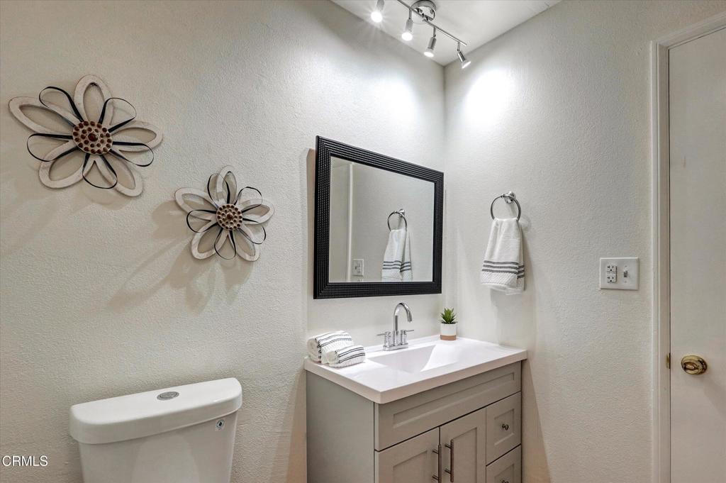 656 Sunfish Way Port Hueneme, CA 93041 - Photo 13 of 52 a bathroom with a toilet sink and mirror