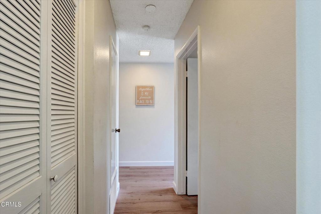 656 Sunfish Way Port Hueneme, CA 93041 - Photo 14 of 52 a view of a hallway with wooden floor