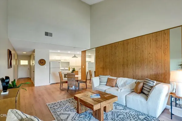 a living room with furniture and a potted plant