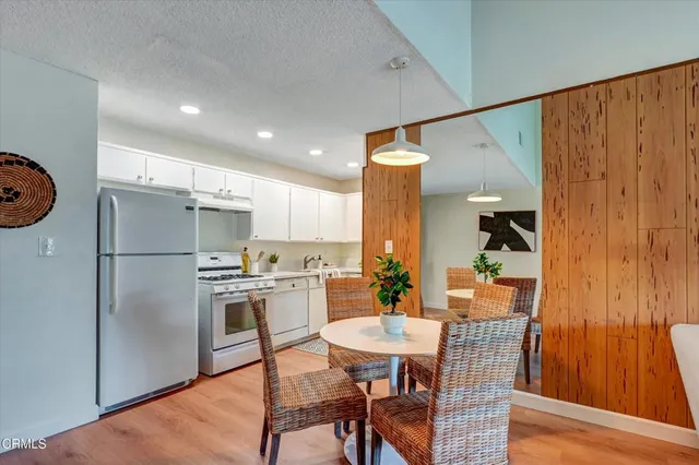a kitchen with stainless steel appliances a refrigerator sink and cabinets