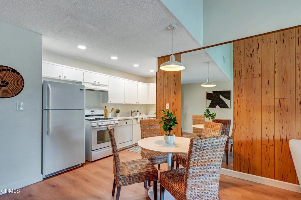656 Sunfish Way Port Hueneme, CA 93041 - Photo 20 of 52 a kitchen with stainless steel appliances a dining table chairs and refrigerator