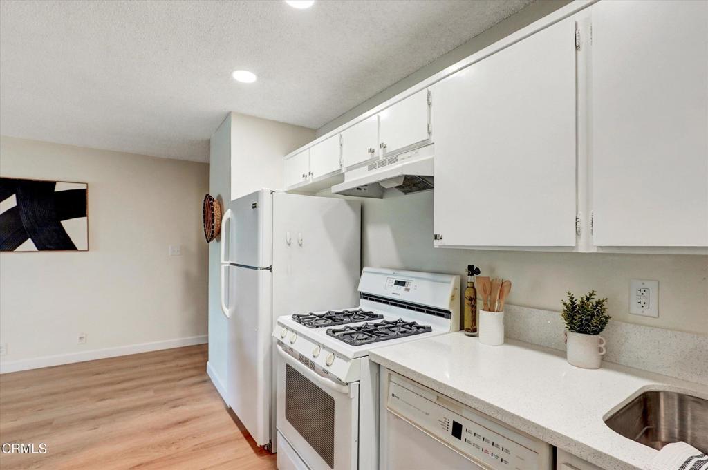 656 Sunfish Way Port Hueneme, CA 93041 - Photo 22 of 52 a kitchen with a white cabinets and white appliances