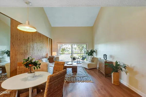 a living room with furniture a large window and a chandelier