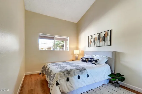 a bedroom with a bed and a painting on the wall