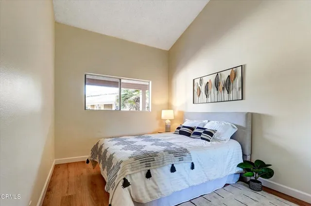 a bedroom with a bed and a painting on the wall