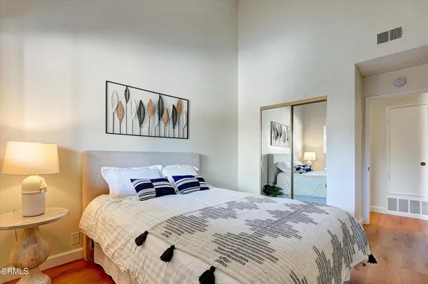 a bedroom with a bed and wooden floor