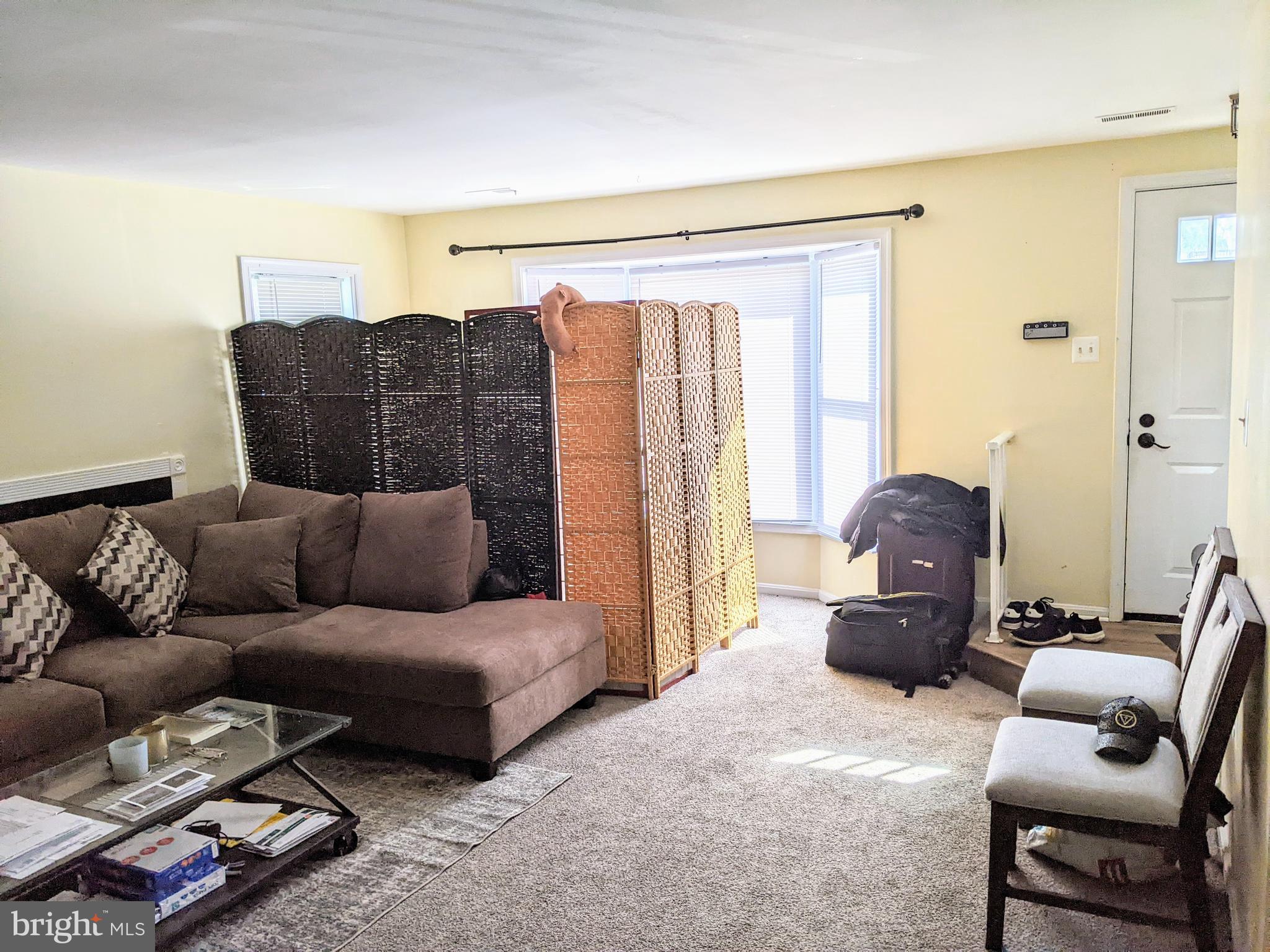 7372 Rokeby Drive Manassas, VA 20109 - Photo 5 of 21 a living room with furniture a lamp and a large window