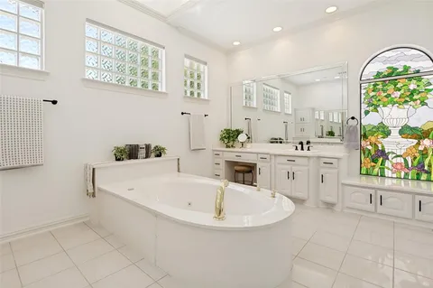 a white bath tub sitting next to a bathroom sink