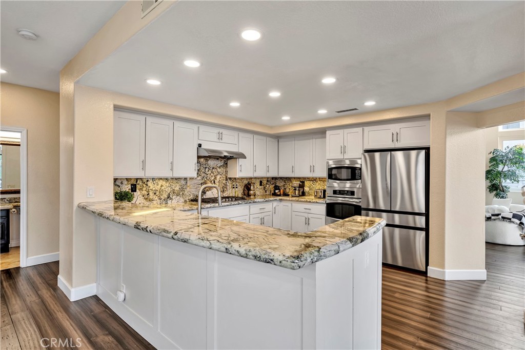 3171 Diamond View Street Corona, CA 92882 - Photo 11 of 49 a kitchen with a refrigerator a sink and cabinets