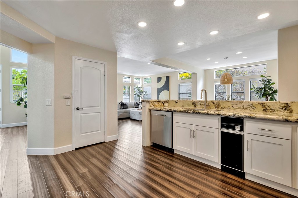 3171 Diamond View Street Corona, CA 92882 - Photo 13 of 49 a kitchen with a sink cabinets and wooden floor
