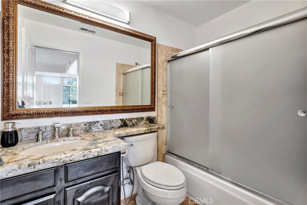 3171 Diamond View Street Corona, CA 92882 - Photo 29 of 49 a bathroom with a granite countertop sink toilet and shower
