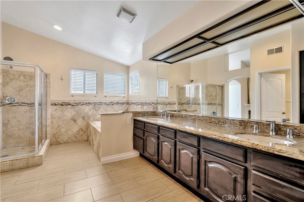 3171 Diamond View Street Corona, CA 92882 - Photo 43 of 49 a large kitchen with granite countertop a sink and cabinets