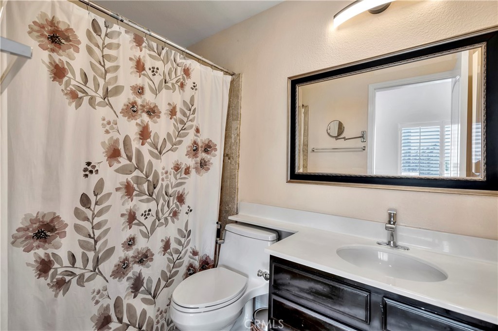 3171 Diamond View Street Corona, CA 92882 - Photo 45 of 49 a bathroom with a toilet a sink and a mirror