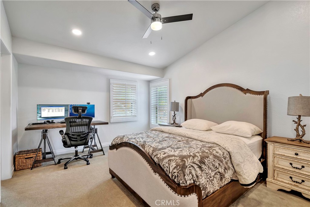 3171 Diamond View Street Corona, CA 92882 - Photo 46 of 49 a bedroom with a bed a chair and a chandelier