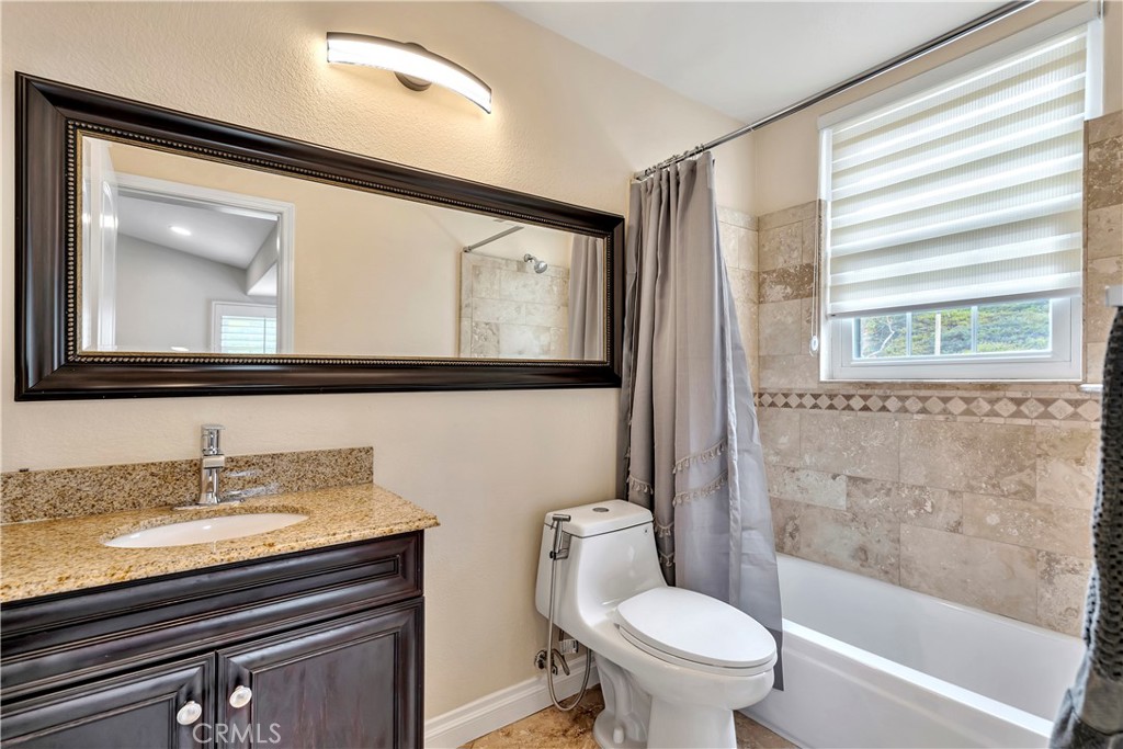 3171 Diamond View Street Corona, CA 92882 - Photo 47 of 49 a bathroom with a toilet a sink and a large mirror
