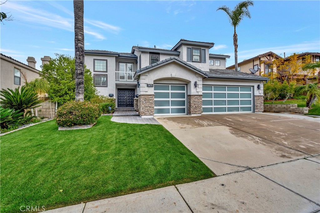 3171 Diamond View Street Corona, CA 92882 - Photo 49 of 49 a front view of a house with a garden and yard