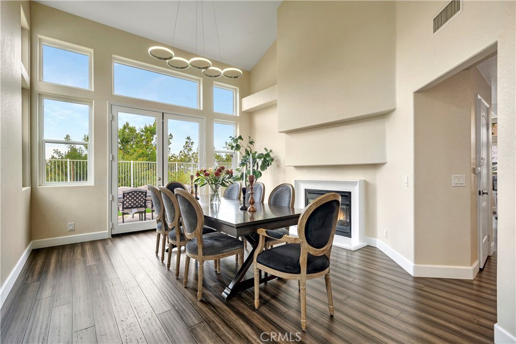 3171 Diamond View Street Corona, CA 92882 - Photo 9 of 49 a dining room with furniture a fireplace and wooden floor