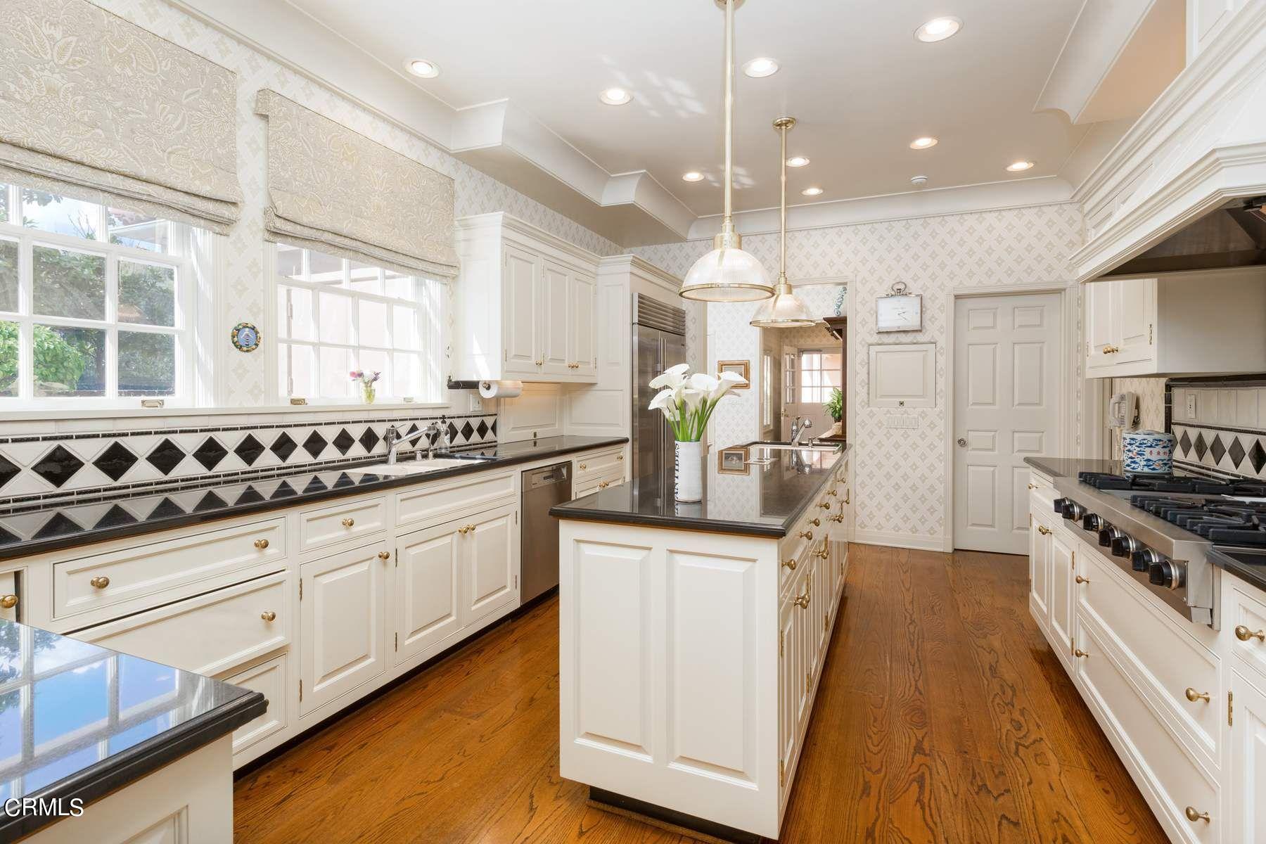 1585 Orlando Road Pasadena, CA 91106 - Photo 15 of 47 a kitchen with granite countertop a sink a stove refrigerator and cabinets