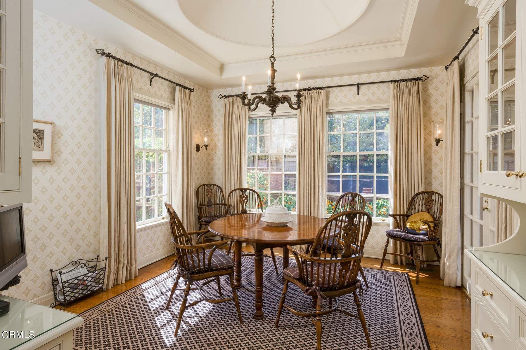 1585 Orlando Road Pasadena, CA 91106 - Photo 17 of 47 a dining room with furniture a chandelier and wooden floor