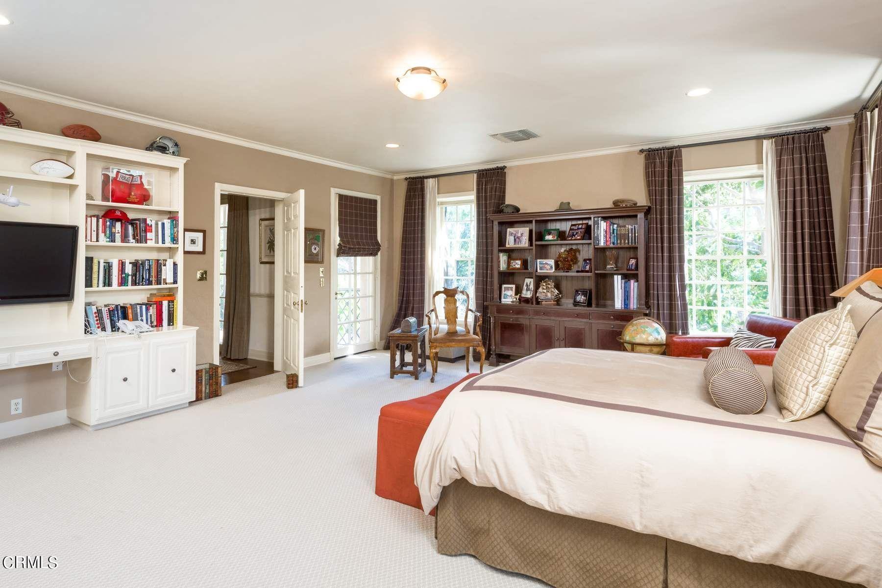 1585 Orlando Road Pasadena, CA 91106 - Photo 26 of 47 a bedroom with a large bed and a flat tv screen