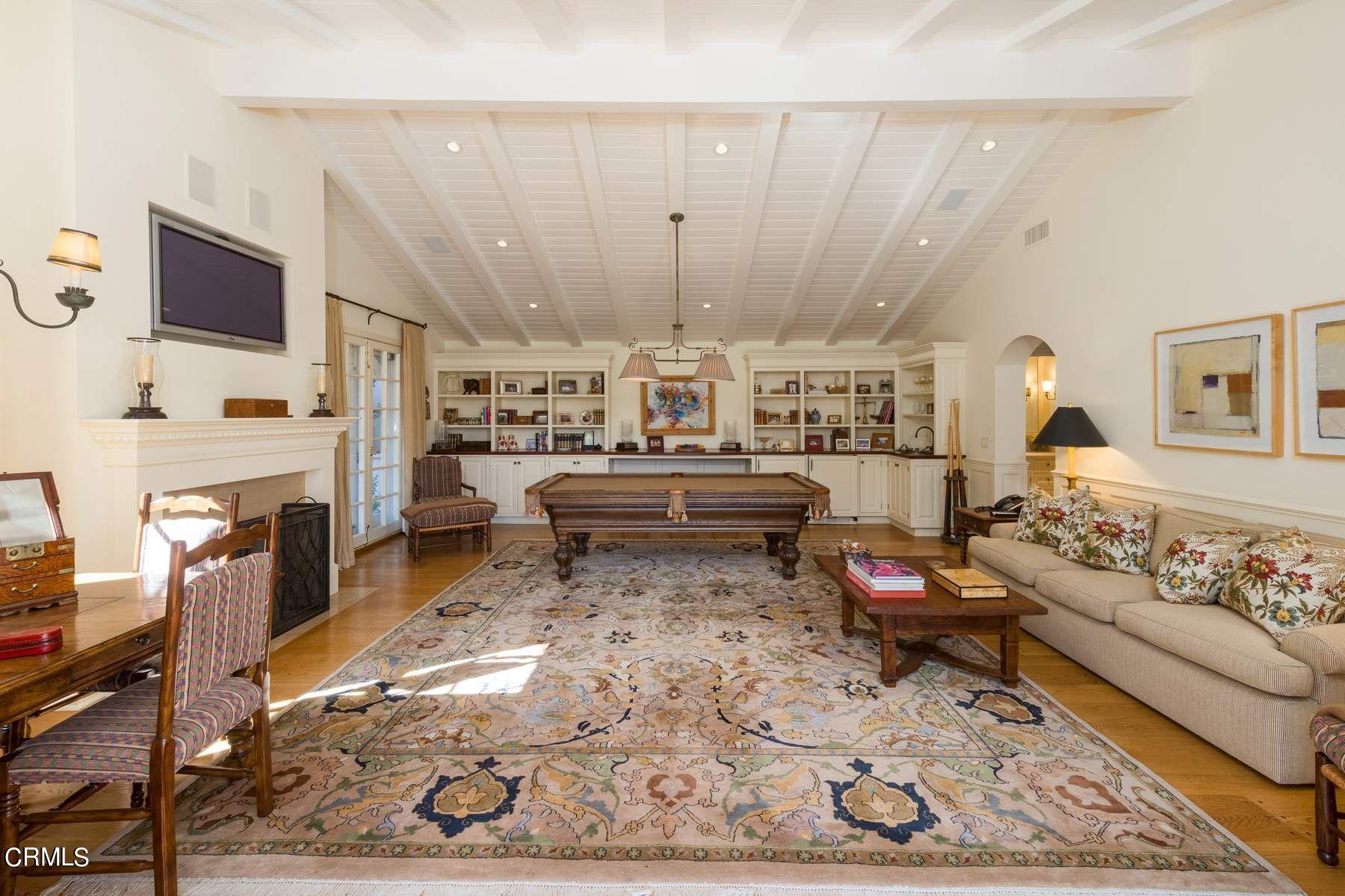 1585 Orlando Road Pasadena, CA 91106 - Photo 40 of 47 a living room with furniture a rug and a flat screen tv