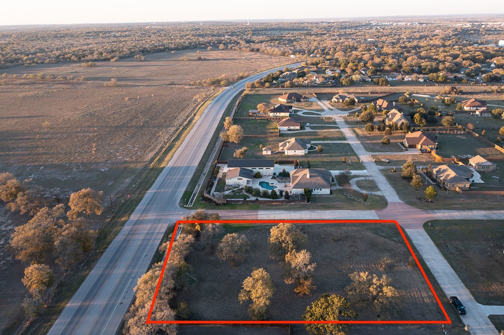 an aerial view of a residential houses with outdoor space