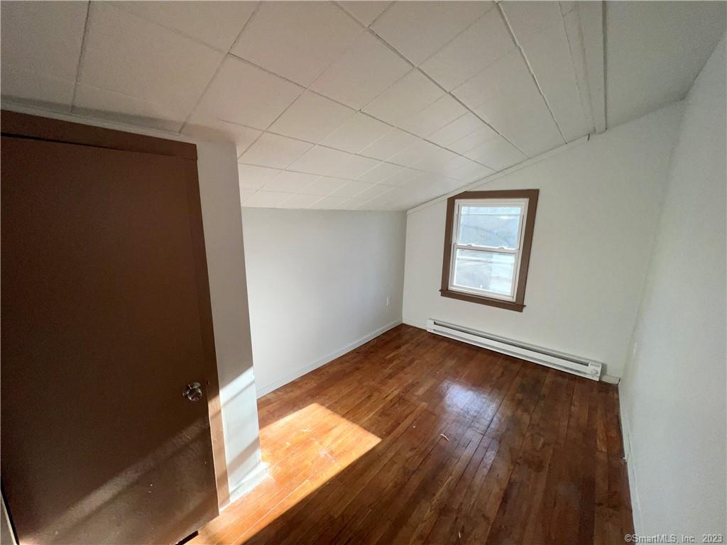 39 Waterbury Road, Unit E3 Prospect, CT 06712 - Photo 13 of 17 an empty room with wooden floor and windows