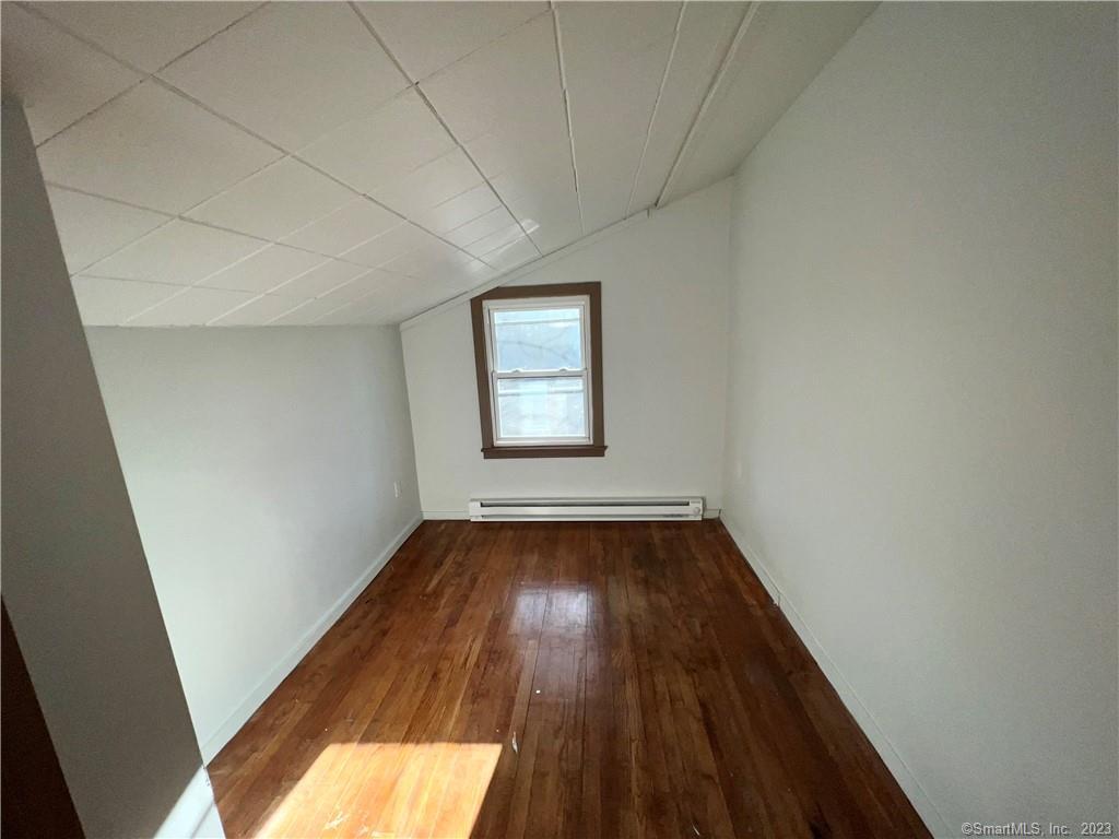 39 Waterbury Road, Unit E3 Prospect, CT 06712 - Photo 14 of 17 an empty room with wooden floor and windows