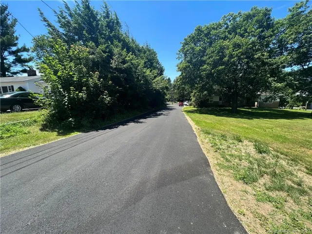 a view of a pathway with a yard