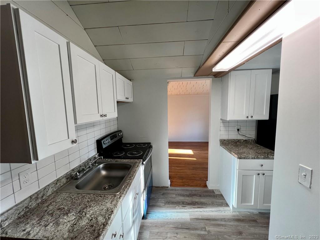 39 Waterbury Road, Unit E3 Prospect, CT 06712 - Photo 4 of 17 a kitchen with granite countertop a sink a stove and refrigerator