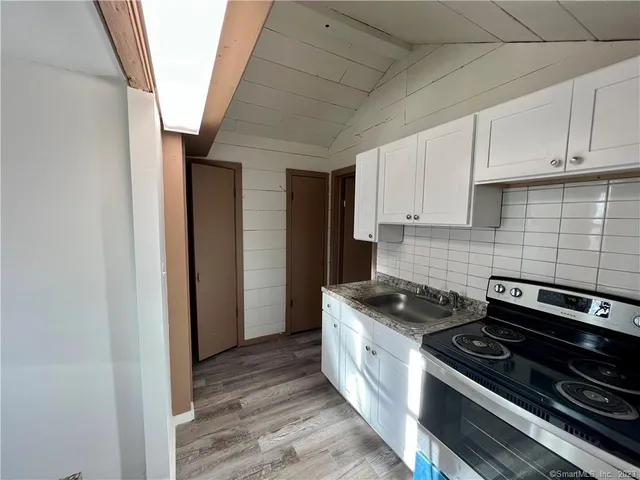 a kitchen with sink and cabinets