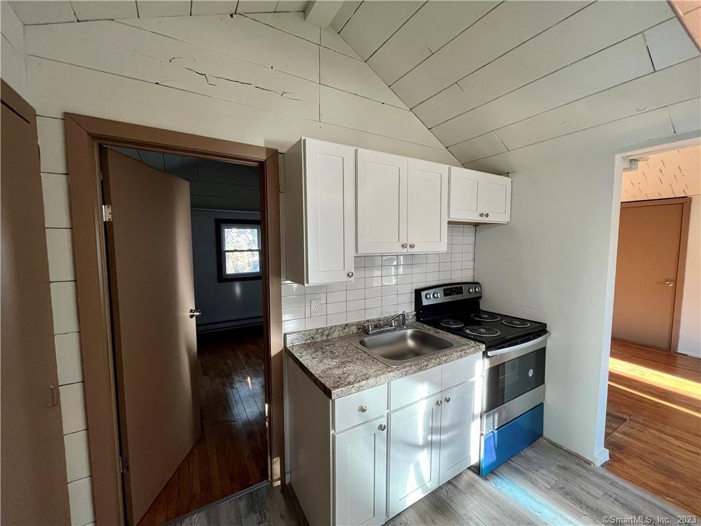 39 Waterbury Road, Unit E3 Prospect, CT 06712 - Photo 6 of 17 a kitchen with stainless steel appliances granite countertop a stove a sink and a refrigerator