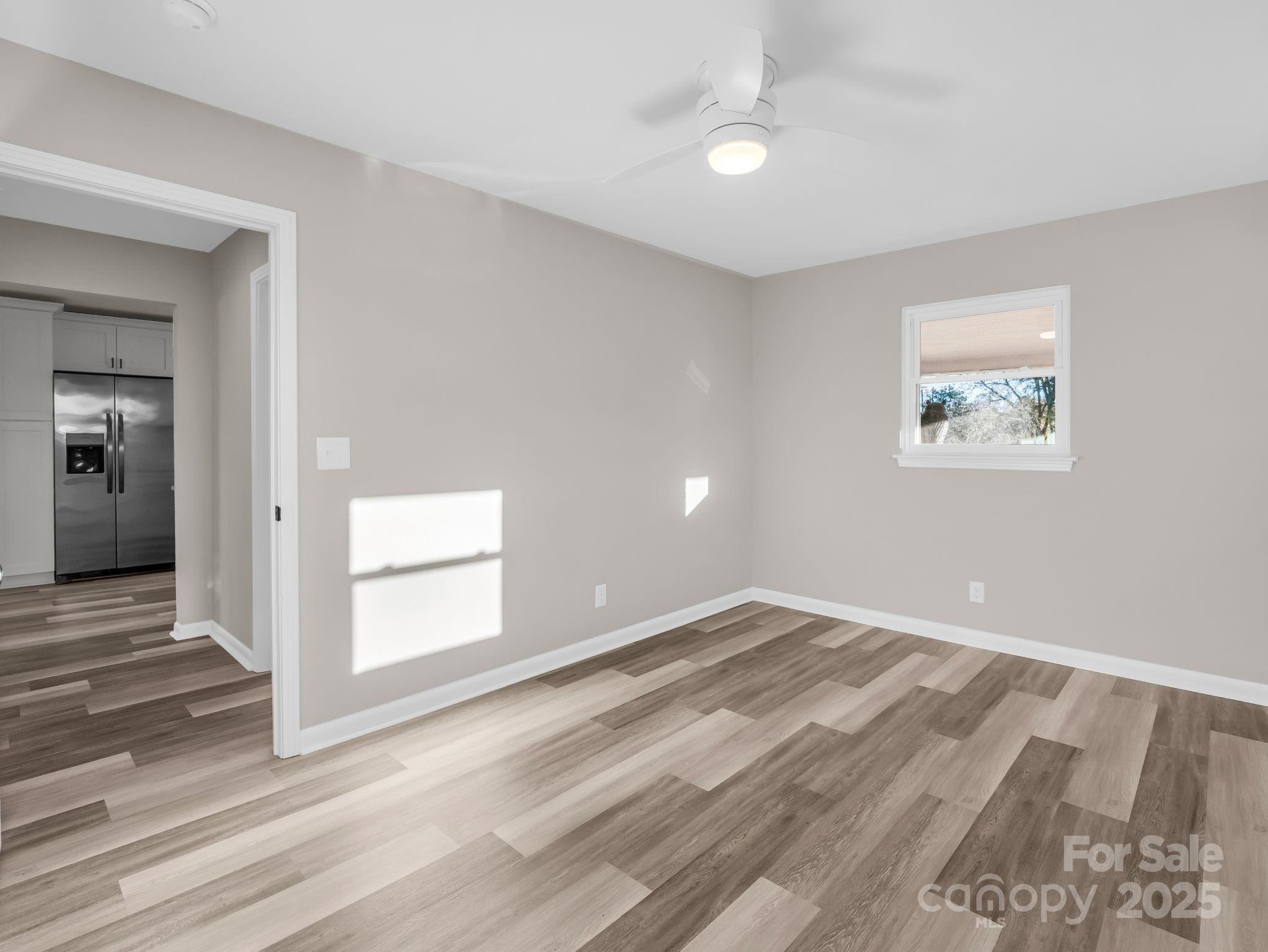 1696 Race Path Church Road Mooresboro, NC 28114 - Photo 16 of 31 a view of an empty room with wooden floor and a window