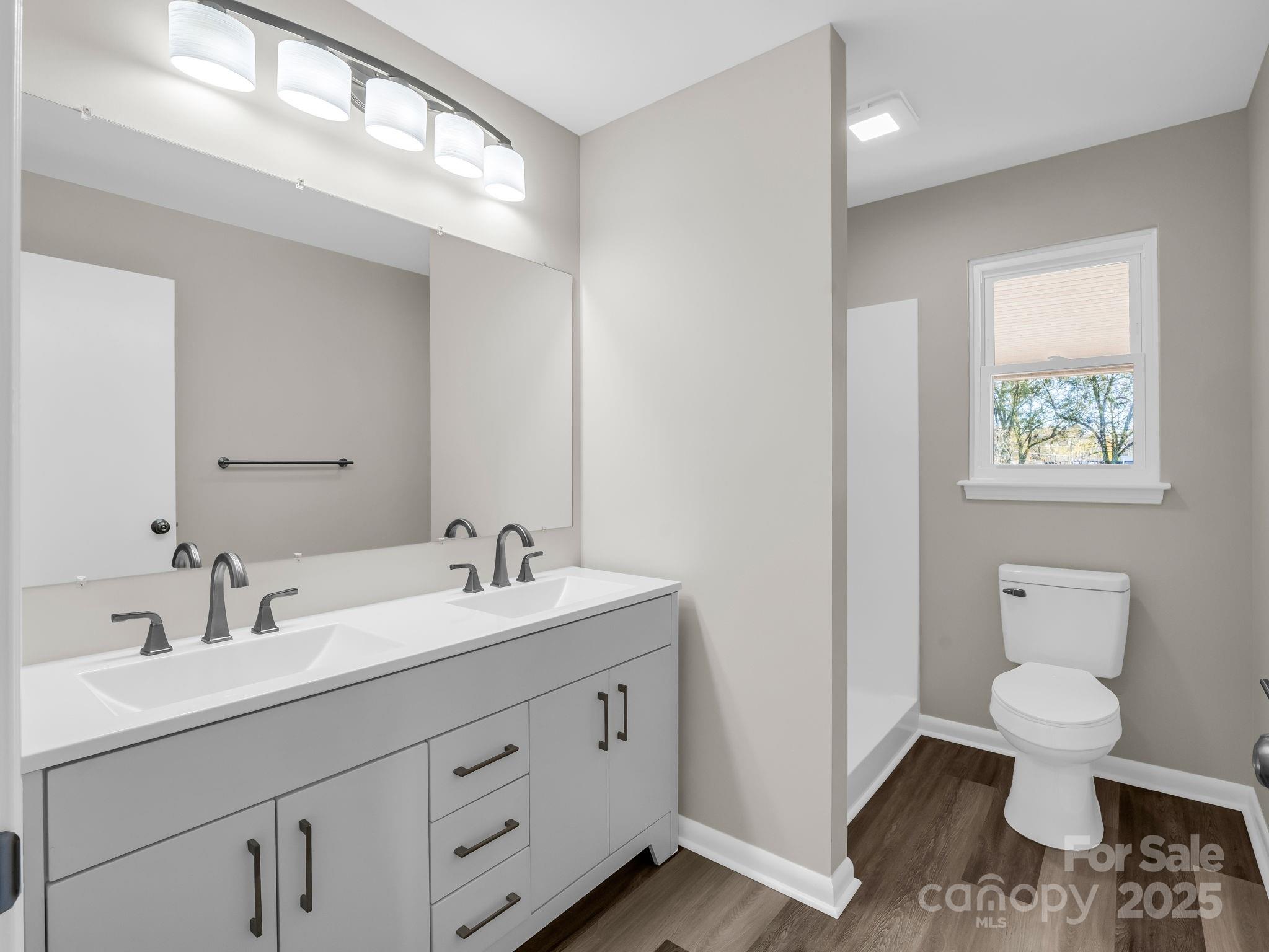 1696 Race Path Church Road Mooresboro, NC 28114 - Photo 18 of 31 a bathroom with a toilet sink and mirror