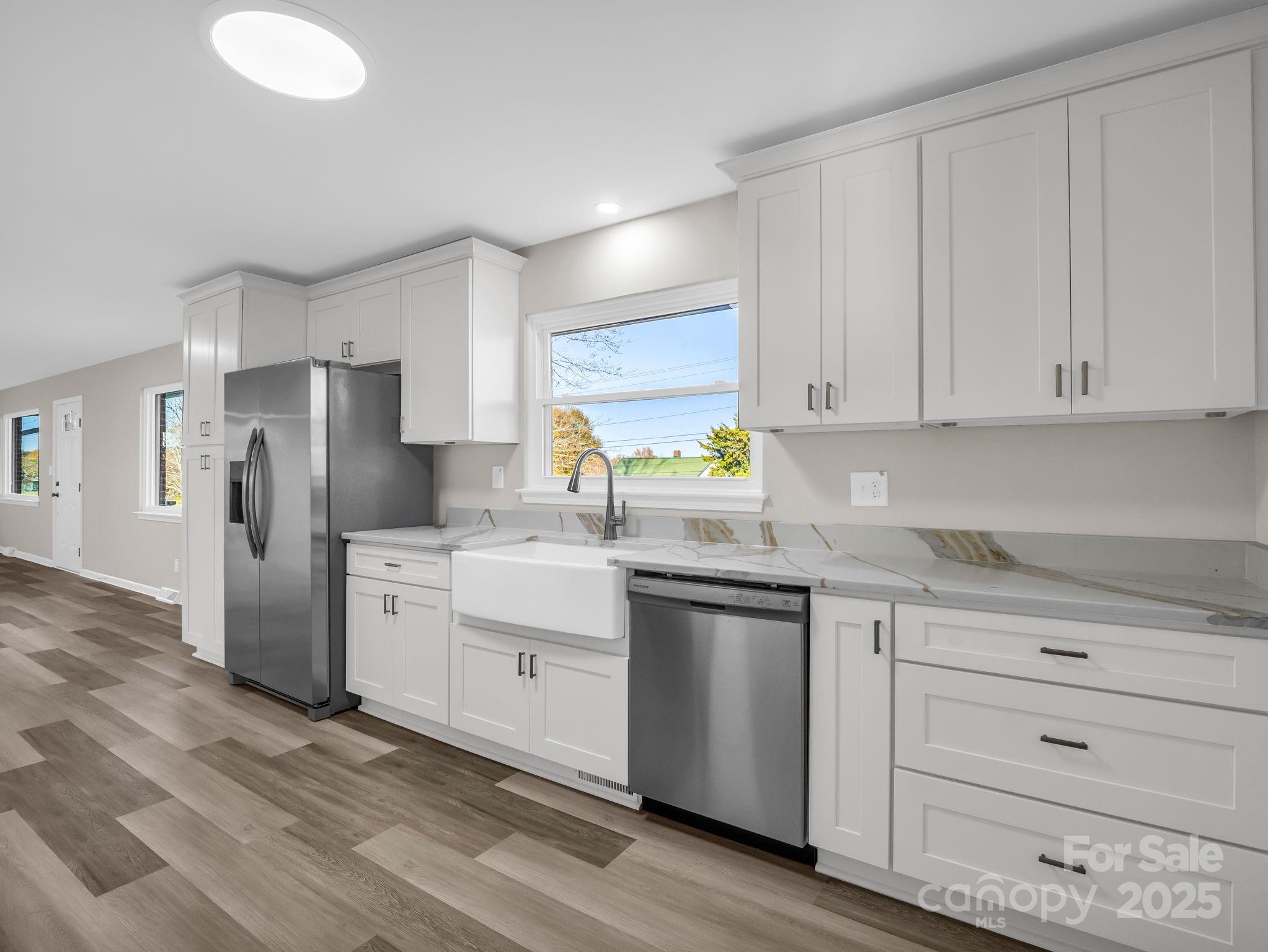 1696 Race Path Church Road Mooresboro, NC 28114 - Photo 8 of 31 a kitchen with white cabinets and stainless steel appliances