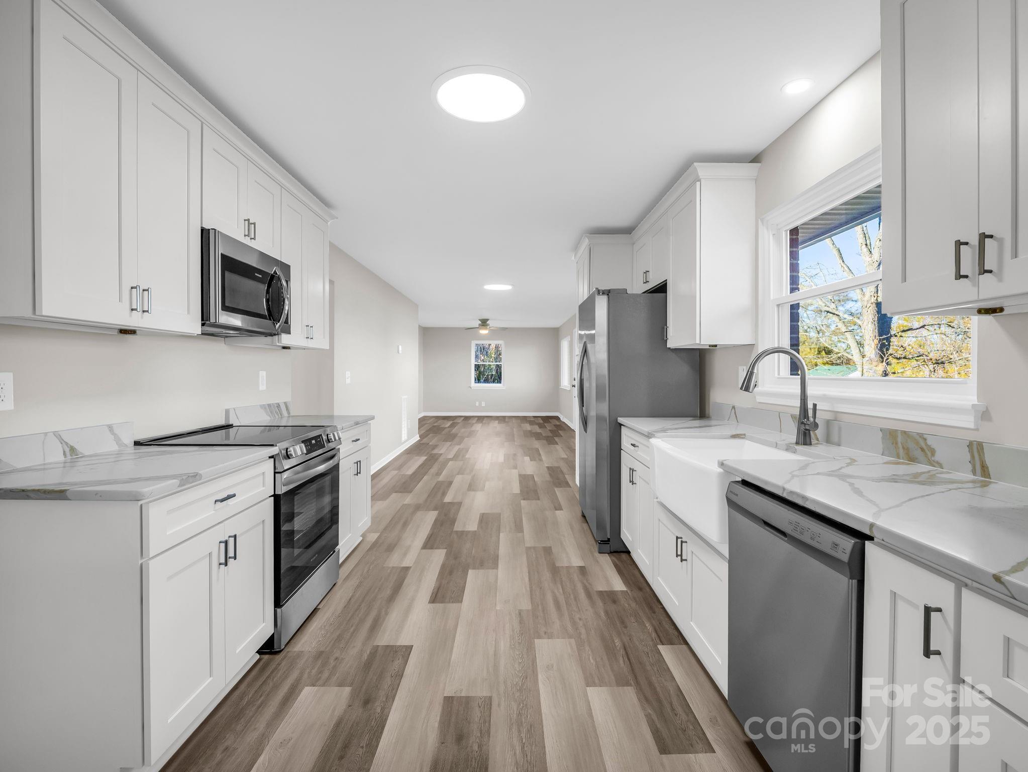 1696 Race Path Church Road Mooresboro, NC 28114 - Photo 9 of 31 a large kitchen with stainless steel appliances granite countertop a lot of counter space and wooden floor